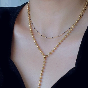 Minimalist gold double layer necklace with black beads and ball chain Y-shaped design