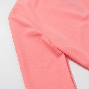 Détail de la texture lisse du tissu rose et couture de la manche d'une robe longue