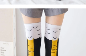 Detail of creative chicken leg pattern socks featuring knitted yellow and black design
