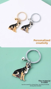 Detail of German Shepherd keychains with gold and silver bells and alloy hooks