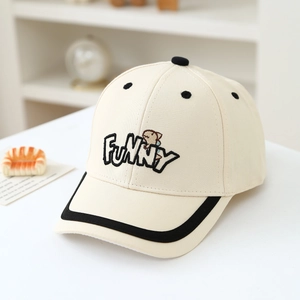 Detail of cream kids baseball cap with FUNNY embroidery and cute bear mascot