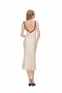 Detail of French retro polka dot dress back with black lace trim and V-neck tie design