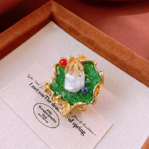 Vintage gold-plated freshwater pearl brooch with colorful gemstones on art card
