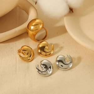 Minimalist 18K gold and silver chunky comma earrings and ring jewelry set on warm ceramic