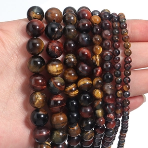 Close-up of natural red tiger eye stone beads showing unique chatoyancy and glossy texture