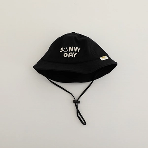 Close-up of black cotton kids bucket hat with sunny face embroidery and windproof cord