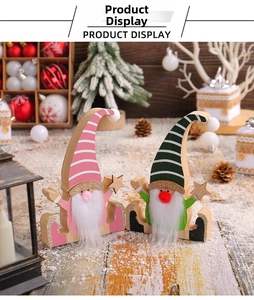 Close-up of pink and green wooden Christmas gnomes with plush beards in festive decor