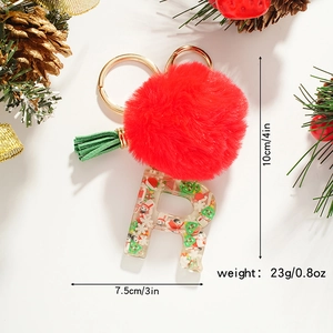 Detailed view of Christmas letter R keychain with red pompom and resin elements