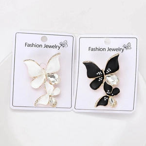 Detail of elegant butterfly brooches with rhinestones in black and white styles