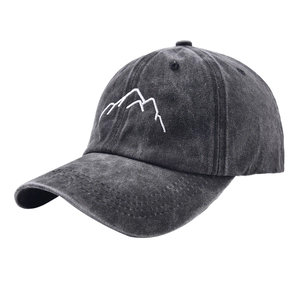 Close-up of white mountain embroidery on charcoal grey washed cotton baseball cap