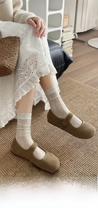 Detail of cream-colored cotton socks with openwork knit texture and soft breathable fabric
