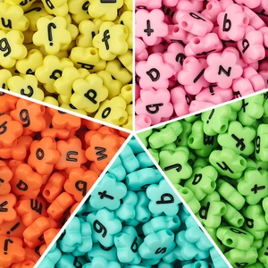 Macro detail of colorful flower-shaped acrylic letter beads for DIY jewelry making