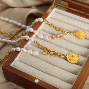 Elegant baroque pearl and gold chain necklace with Elizabeth II coin pendant in a jewelry box