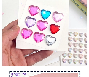 Close-up of colorful 3D heart-shaped crystal gemstone stickers for children in various colors