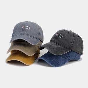 Detailed view of assorted distressed cotton baseball caps with 1% battery embroidery
