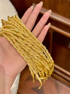 Detailed close-up of golden multi-strand twisted rope bracelets with sparkling texture