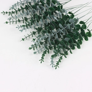 Artificial eucalyptus branch with frosted green leaves for home and wedding decor