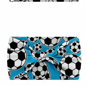Macro detail of the knot design on a blue elastic sports headband with football patterns