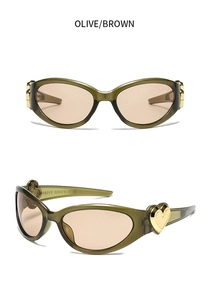 Detail view of olive cat eye sunglasses featuring gold heart-shaped metal accents on hinges