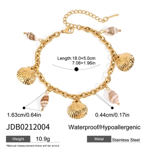 Detailed view of sea shell charms on a gold stainless steel beach anklet with measurements