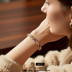 Vintage gold bracelet with oval multi-color gemstones and sparkling zircon accents