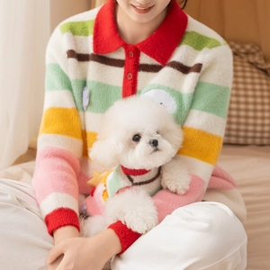 Matching colorful striped knit sweaters for dogs and owners in soft plush fabric