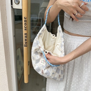 Detail of canvas tote bag interior showing the inner pocket and snap button closure