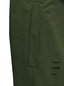 Detail of dark green knit shorts showing side pocket stitching and ripped distress accents