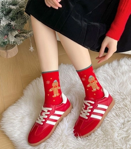 Detailed close-up of Christmas socks featuring gingerbread man and snowflake patterns