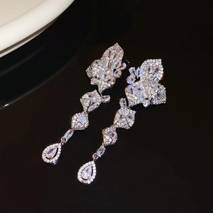 Detailed macro view of sparkling zircon flower earrings with long elegant tassels