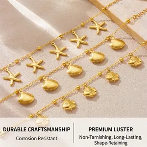Close-up of gold stainless steel ocean charms featuring starfish, shells, and tropical fish