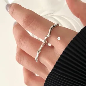 Detail of S925 sterling silver ring set featuring hand-woven twist and wave designs