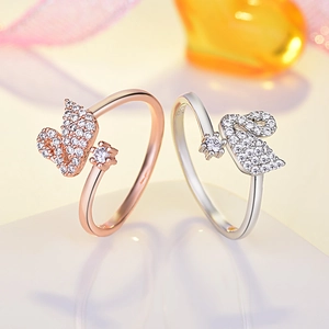 Detail view of swan-shaped rings with pave-set crystals in rose gold and silver finish