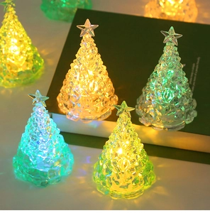 Detailed view of LED crystal Christmas tree lights glowing in warm yellow and green