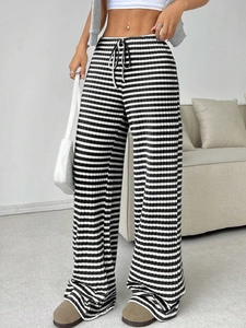 Detailed view of striped wide-leg pants featuring drawstring waist and knit texture