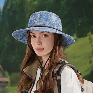 Blue tie-dye outdoor sun hat with wide brim, brown leather trim, and adjustable chin strap