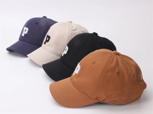 Detail showing various colors of cotton baseball caps with embroidered P and Paris logo