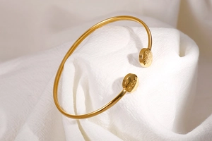 Detailed view of Hope engraving and tree motif on gold plated stainless steel cuff