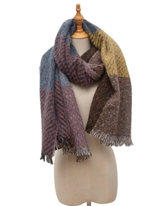 Detail of a thick plaid scarf with purple and blue blocks and woven fringe texture