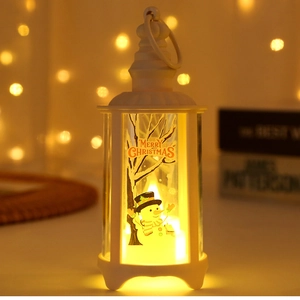 Detail of white Christmas lantern with snowman print and warm LED light in soft bokeh background