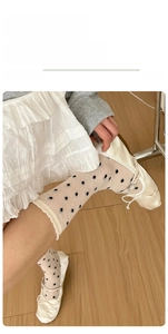 Breathable cream polka dot mesh socks with ruffled trim paired with ballet flats