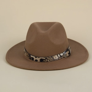 Close-up of leopard print band and silver metal buckle on brown wool fedora hat
