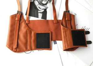 Close-up of vintage brown leather harness belt with metal buckles and texture detail