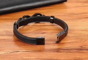 Macro shot of double-layer black braided leather bracelet with black magnetic metal clasp