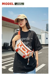 Outdoor leisure chest bag featuring white fabric with vibrant orange strap details