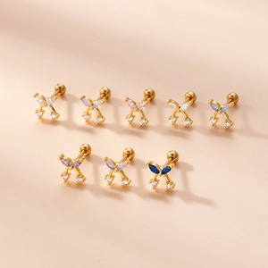 Cute mini gold bow cubic zirconia stainless steel stud earrings set on pink background