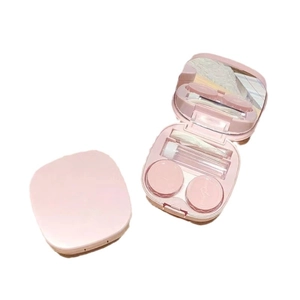 Pink minimalist portable contact lens case set with tweezers and mirror on white background