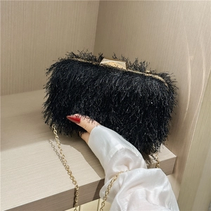 Elegant black feather evening clutch with golden buckle and chain strap for women