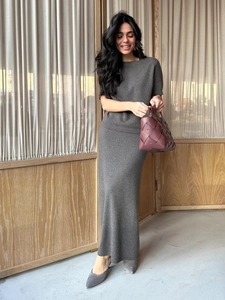 Detail of dark grey knit two-piece set featuring a short-sleeved top and long skirt