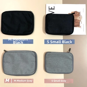 Black and grey portable tech organizers in M and S sizes for Apple Watch bands and cables